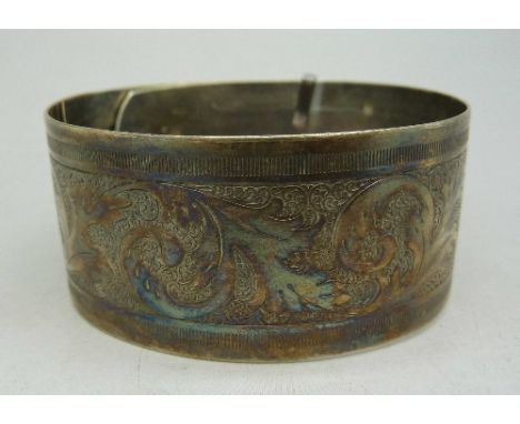 A silver bangle, Chester 1945, bears inscription, weight 31g