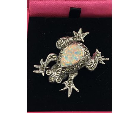 A silver frog brooch set with marcasite's and opal panel.