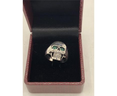 An unusual skull shaped ring with Emerald eyes.