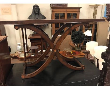 A sofa table with campaign style legs