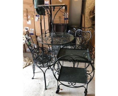 A selection of wrought iron garden furniture in green to include round table with four chairs, small round table, a small rec