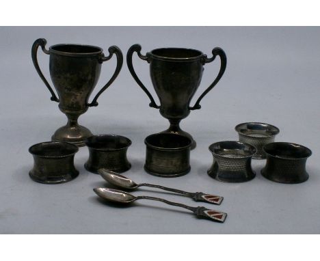 A silver twin-handled trophy cup, London 1935, another London 1934, a set of five engine turned silver napkin rings and anoth