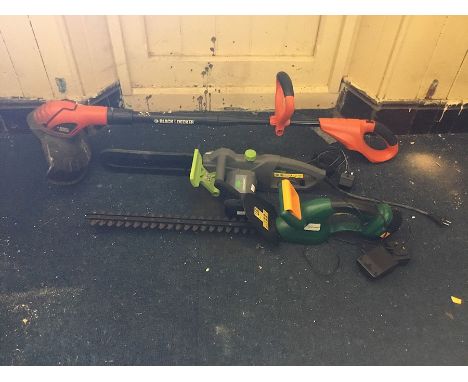 A petrol BMC Racer Lawn mower, a Black &amp; Decker strummer (battery and charger present), a battery powered hedge trimmer (