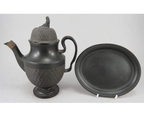 An early nineteenth century black basalt coffeepot and cover and a similar teapot stand, c.1810. Both are unmarked. Teapot st