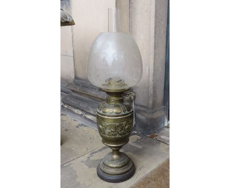A Victorian hammered brass oil lamp with frosted glass shade, the wick adjuster stamped H and B, Birm, 61cm high