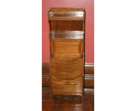 An early 29th century oak combined smoker's cabinet/bookshelf and magazine rack and a 1970's occasional table with insert til