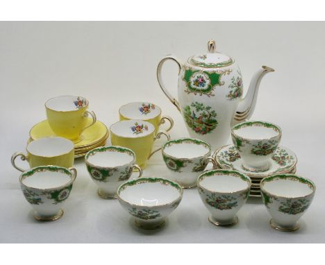 A Bone China tea set by Foley comprising:- a teapot, six cups and saucers and a sugar bowl and a milk jug together with four 