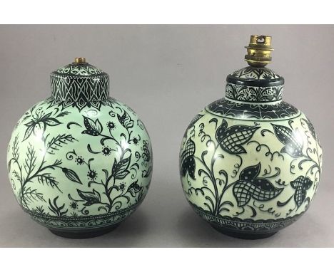 Two mid 20th century ceramic lamp bases, painted underglaze with stylised floral designs and patterned borders, H. 22 cms [2]