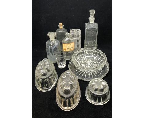 An assortment of glass, mid 20th century to include:-&nbsp; two medical jars, three jelly moulds, a decanter (11)&nbsp;