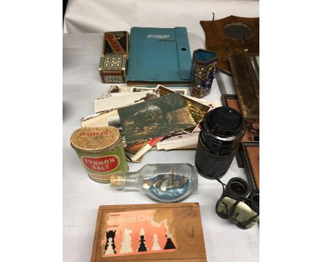 A COLLECTION OF ITEMS INCLUDING A STAMP ALBUM, CHESS PIECES, CAMERA LENS, MINI BINOCULARS, OLD POSTCARDS, ETC 