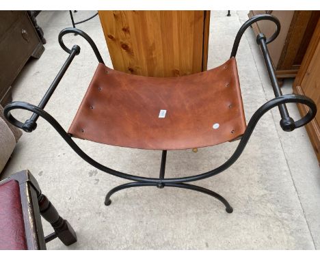 A CAST METAL SCROLLED STOOL WITH LEATHER SEAT 