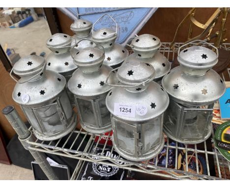 A COLLECTION OF EIGHT DECORATIVE TEA LIGHT LANTERNS 