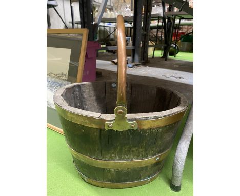 A VINTAGE WOODEN BUCKET WITH COOPERED BRASS BANDS AND BRASS HANDLE 