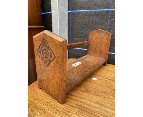 A MID 20TH CENTURY OAK BOOK TROUGH WITH INSET CARVING TO END PANELS, 15" WIDE 