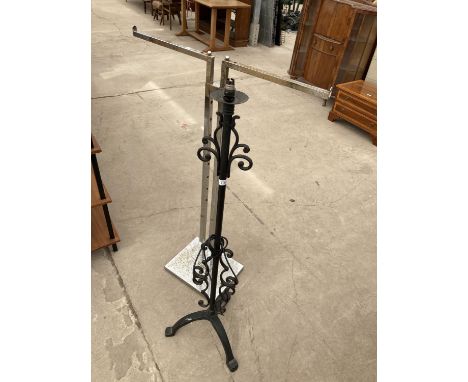A WROUGH IRON STANDARD LAMP AND A CHROME ADJUSTABLE CLOTHES RACK 