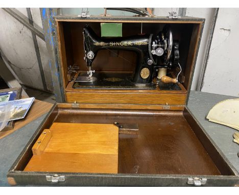 A VINTAGE BOXED SINGER SEWING MACHINE ON A MAHOGANY BASE 