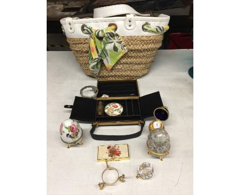 A WICKER BAG CONTAINING A COTY BAG WITH COMPACT AND PERFUME, DECORATIVE EGGS AN EGG CLOCK, ETC 