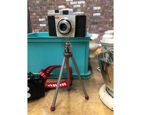 A VINTAGE KODAK COLORSNAP 35 ON AN ADJUSTABLE METAL TRIPOD 