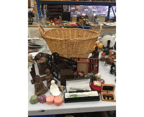 A LARGE BASKET CONTAINING A QUANTITY OF COLLECTABLE ITEMS TO INCLUDE BUDDAHS, ABACUS', BOXES, ANIMAL FIGURINES, PENS, ETC 