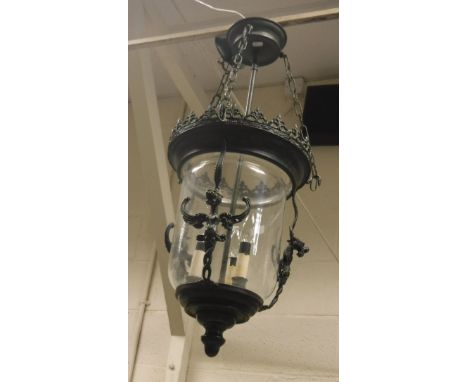 A verdigris patinated metalwork and glass ceiling light in the Gothic Revival taste with grotesque beast decoration