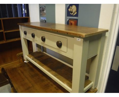 A modern pine dresser, the polished top on a green painted base with two frieze drawers on square supports united by a pot sh