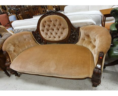 A Victorian walnut framed show frame salon sofa with carved decoration