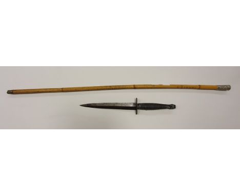 An SAS dagger with ribbed handle and engraved blade, housed in a leather scabbard, together with a cane swagger stick, the fi