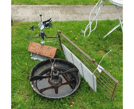 A wrought iron feeder, together with a weather vane, housed on a terracotta tile, a gate section, metal doormat and a painted