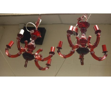 A pair of ruby glass and plastique five branch electroliers in the Victorian taste