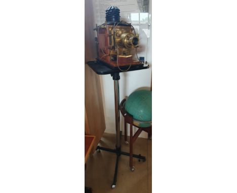 A Victorian mahogany box cased and brass magic lantern adapted for modern use, together with a large selection of coloured la