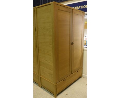 An Ercol oak two door wardrobe with single drawer to base (to match Lot 498)Dimensions (Approx): Height 189cm / Depth 61cm / 