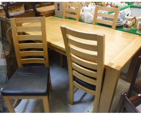 A modern oak rectangular dining table and four ladder back chairs with upholstered seats (ex TR Hayes, Bath) together with an