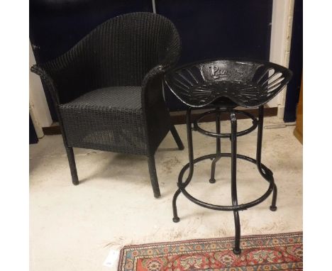 A pair of Eastward Lloyd Loom black painted tub chairs together with a pair of black painted tractor seat stools, a painted E