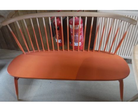 An Ercol beech framed and orange painted stick back love seat on turned splayed supports united by stretchers CONDITION REPOR