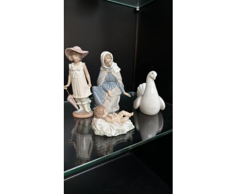 Set of four NAO by Lladro porcelain figurines, including a girl with a parasol, Madonna and child, baby Jesus, and a dove. Th