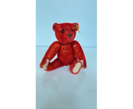 Steiff miniature red mohair teddy bear with signature "Knopf im Ohr" button and tag. Articulated limbs, charming design.