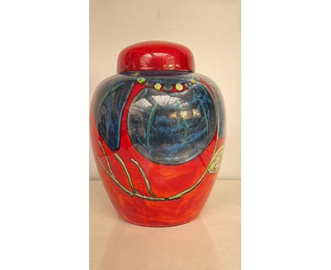 Large Poole Pottery lidded jar, England. Striking hand-painted design in vibrant red, blue, and green glazes. Marked to base.