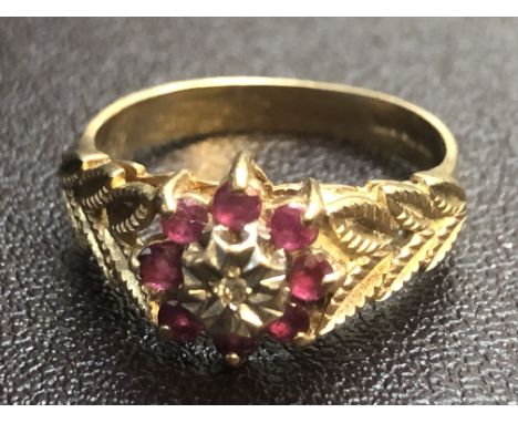 9ct Gold ring central diamonds surrounded by 8 rubies Size M Weight 2.6g 