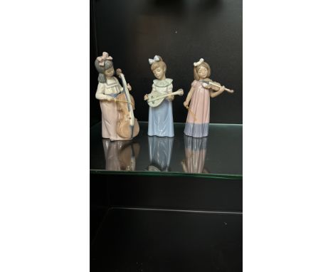 NAO by Lladró porcelain figurine trio, depicting young girls playing musical instruments, crafted in Spain with delicate past
