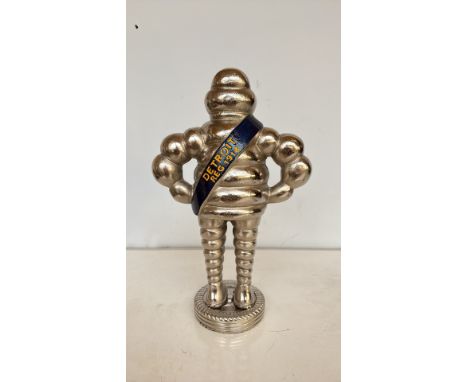 Michelin Bibendum figurine, cast metal with silver-tone finish. Features "MICHELIN" sash on front and "DETROIT REG 1918" on r