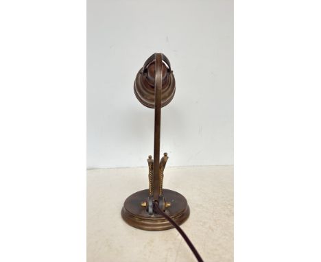 Vintage brass adjustable desk lamp with a decorative Art Deco-inspired base and intricate detailing. The lamp has a pivoting 