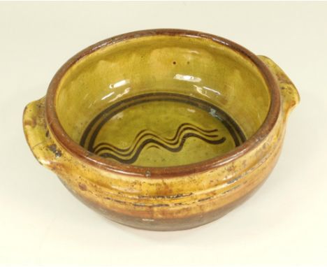 MICHAEL CARDEW & ELIJAH COMFORT.A Winchcombe Pottery twin-handle casserole by Michael Cardew & Elijah Comfort. Lacks lid. Mic