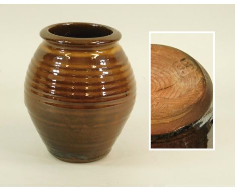 LEACH POTTERY. A red earthenware, Leach Pottery slipware, ribbed vase. Impressed Pottery mark. Height 19cm. Hairline crack.