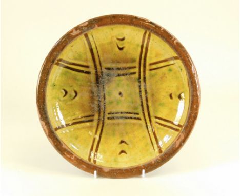 MICHAEL CARDEW. A Winchcombe Pottery dish by Michael Cardew c1930. Personal &amp; Pottery marks. Diameter 26cm. Some crawl &a