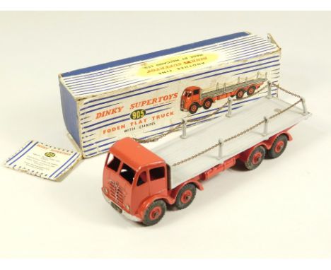 DINKY TOYS. A Foden flatbed with chains. Model 905. Back two pillars slightly bent. Some minor chips, VG. Box poor.