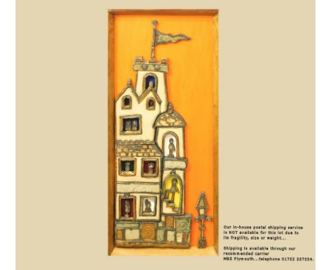 POTTERY PLAQUE. A stoneware architectural plaque of a multi-storied building with lamp post. Mounted on painted plywood &amp;