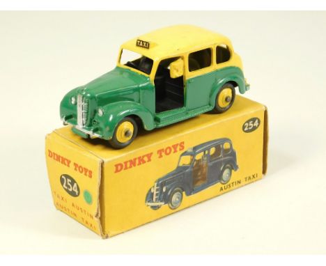 DINKY TOYS. An Austin Taxi. Model 254 green &amp; yellow version. Some minor chips, VG/VNM. Box good but with some wear.