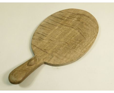 MOUSEMAN. A Mouseman (Robert Thompson of Kilburn) oak cheese board with carved mouse handle. Length 39cm. Width 20.5cm.