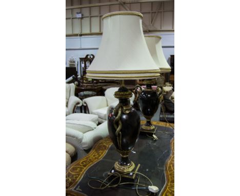 Pair of urn shape lamp bases with twin serpent handles, ivory coloured shades.