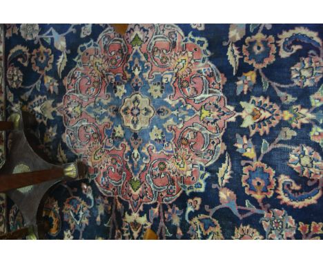 Mehsed carpet, central light blue ground floral medallion on a dark blue field with trellis pattern within guards, broad mean